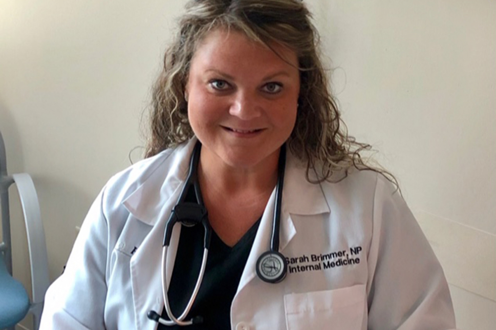 Sarah Brimmer posing with her lab coat on