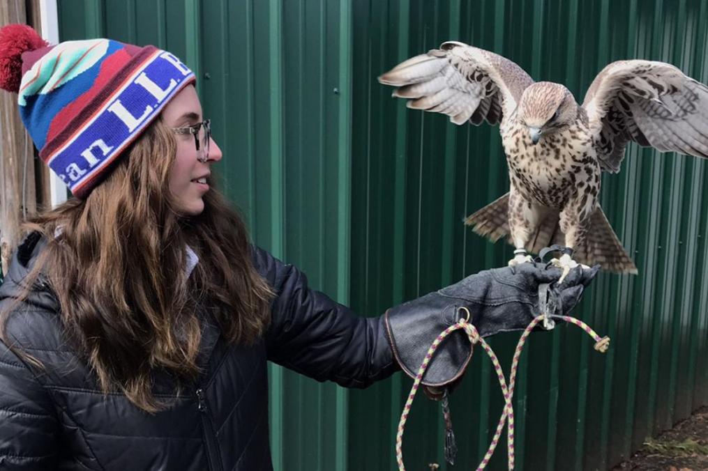 Grace DelRossa with a bird sitting on her left hand