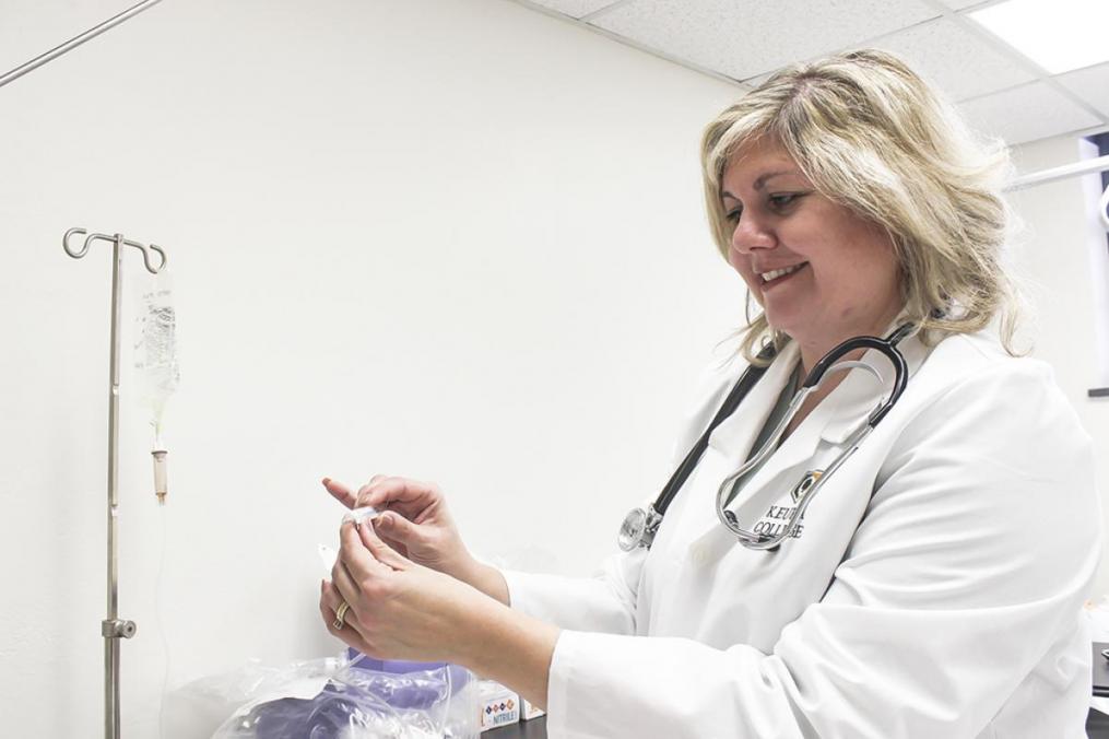 Nursing chair Professor Dr. Beth Russo holding a thermometer