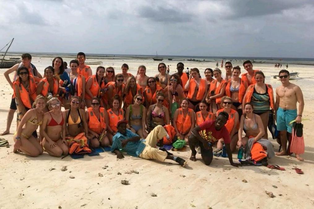 Tessa Alianell with a group of peers on a beach