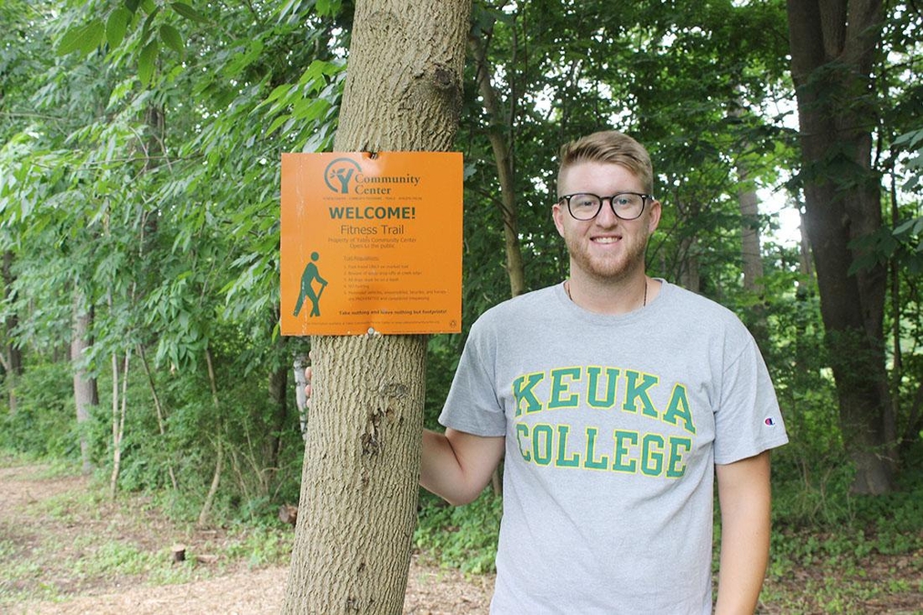 Dan Lazzaro posing next to a tree