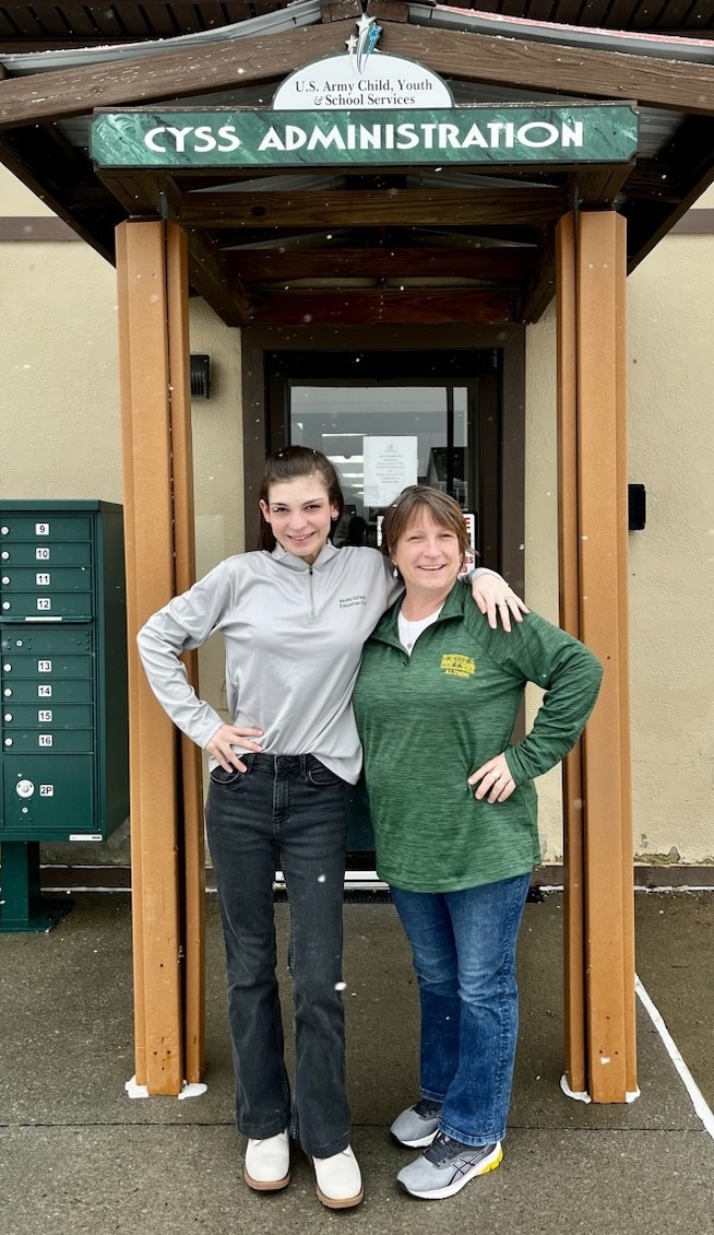 Jenna Heirzholzer '24 poses with Field Period site supervisor in front of CYSS Building